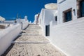 Tourist taking pictures of the beautiful alleys of Santorini Island in a beautiful early spring