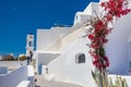 Tourists taking pictures at the beautiful alleys of Santorini Island in a beautiful early spring