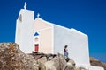 Young tourist girl visiting a beautiful small church next to the walking path between Fira and