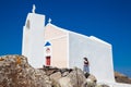 Young tourist girl visiting a beautiful small church next to the walking path between Fira and