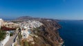 Santorini, Greece - August 7, 2021: View over the roofs of the typical houses of Santorini, island in the cyclades archipelago in Royalty Free Stock Photo