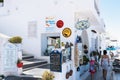 Woman with kids are walking along narrow street at Thira town. Thira town is a capital of island.