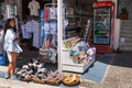 Young girl is bying souveniers at small gift shop.