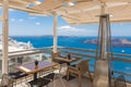 Cafe on terrace. Santorini island, Greece. Beautiful travel destination. Luxury vacation, idyllic summer holiday