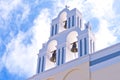 Santorini Greece Church with bells and cross against blue sky