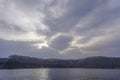 Santorini, Greece: Early morning sunshine breaks through the clouds