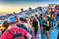 SANTORINI, GREECE - JULY 12, 2014: Tourists enjoy sunset in Oia