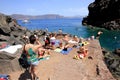 Santorini, Greece, June 15th, 2018: Tourists sunbathing on Amoudi Bay beach, Santorini, Greece