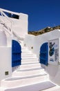 Santorini, Greece: A little blue gate against white washed steps of a typical restaurant against blue sky