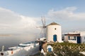 SANTORINI, GREECE - MAY 2018: Iconic panoramic view over Oia village and old traditional windmill on Santorini island, Greece Royalty Free Stock Photo