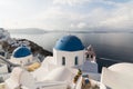 SANTORINI, GREECE - MAY 2018: Traditional Greek orthodox blue dome church on a sunny summer day. Cyclades Islands, Greece Royalty Free Stock Photo