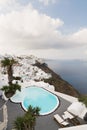 SANTORINI, GREECE - MAY 2018: View over Aegean sea, Firostefani village and volcano caldera with luxury hotel and infinity swimmin Royalty Free Stock Photo