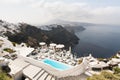 SANTORINI, GREECE - MAY 2018: View over Aegean sea, Firostefani village and volcano caldera with luxury hotel and infinity swimmin