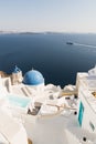 SANTORINI, GREECE - MAY 2018: View over Aegean sea, Oia village and volcano caldera with luxury hotel and infinity swimming pool o