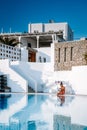 Santorini Greece Oia, young men in swim short relaxing in the pool looking out over the caldera of Santorini Island Royalty Free Stock Photo