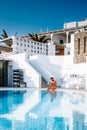 Santorini Greece Oia, young men in swim short relaxing in the pool looking out over the caldera of Santorini Island Royalty Free Stock Photo