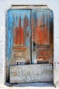 An old damaged blue door on the island of Santorini, Greece