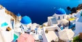 Santorini, Greece. Panoramic view of traditional houses in Santorini. Small narrow streets and rooftops of houses, churches and ho