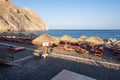 Black Beach with volcanic sand in Perissa, a tourist resort in Santorini. Cyclades, Greece