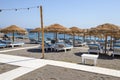 Sun loungers on the black volcanic sand beach of Perissa on the island of Santorini.