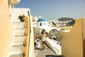 Santorini, Greece - September 11, 2017: Teenager girls or tourists traveling together taking pictures and recording video vlogs in