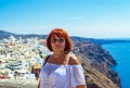 Mature vacationer woman on the cliff edge of the Caldera Santorini Greece Royalty Free Stock Photo