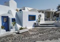 Santorini, Greece: Typical blue and white building exterior greek architecture with plants kept at the entrance