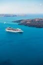 Santorini island, Greece. Cruise ship near the coast. Blue sea and the blue sky Royalty Free Stock Photo