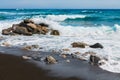 Santorini island, Greece. Waves on the Perissa beach with black volcanic sand Royalty Free Stock Photo