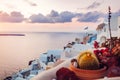 Santorini island Oia sunset landscape. Traditional white houses and greek flag with sea view. Travel to Greece Royalty Free Stock Photo