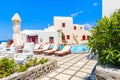 OIA VILLAGE, SANTORINI ISLAND - MAY 23, 2016: Typical greek style apartment hotel with pool in Oia village, Santorini island, Royalty Free Stock Photo