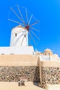 Typical white windmill on street of Oia village, Santorini island, Greece Royalty Free Stock Photo