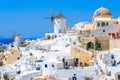 White houses and traditional windmill in Oia village on Santorini island, Greece Royalty Free Stock Photo