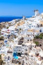 White houses and traditional windmill in Oia village on Santorini island, Greece Royalty Free Stock Photo