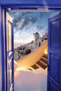 Santorini island with windmill against sunset in Oia village, Greece Royalty Free Stock Photo