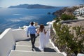 Santorini, Oia, Greece - September 19, 2014: young couple honeymoon on the most romantic island Santorini, Greece, view of Santori