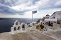 Santorini - Oia, view from the cliff to the caldera. White bell tower on the right and a white roof on the left on the cliff of Royalty Free Stock Photo