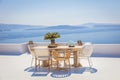 Santorini for rest. Greece, Santorini island, Oia - white architecture and deep blue. Table and chairs on the terrace. Greek Royalty Free Stock Photo