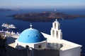 Santorini`s blue dome church and one of the many cruise ships visiting the island. Santorini / Greece - 09/17/2019. Royalty Free Stock Photo