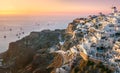 Santorini at Sundown. The famous town of Oia in the sunset. A line of sailing yachts at sea. Romantic holidays. Oia, Santorini,