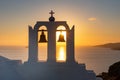 Santorini sunset viewed through a church`s bell tower