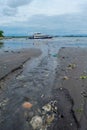 Sanur Beach, Bali, Indonesia February 20, 2021: Morning view on the beach of Sanur, Bali. The flow of river water that leads to Royalty Free Stock Photo