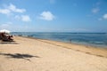 Sanur Beach in Bali, Indonesia with tour boats in the distance.