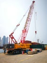 Sany crane uplifting container at Western District Public Cargo Working Area, Victoria Harbour, Hong Kong Royalty Free Stock Photo