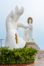 Statue of Guanyin on the territory of Buddhist center Nanshan on a cloudy day