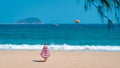 Sanya, Yalong Bay, Hainan, China - May 14, 2019: Beautiful clean beach. A young woman walks along the sandy seashore