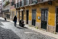 Sao Bento, Lisbon Portugal - Young woman walking over the paved roads in the narrow old streets with typic colorful Royalty Free Stock Photo