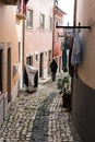 Sao Bento, Lisbon Portugal - Young woman walking in the paved narrow streets and colorful houses with drying Royalty Free Stock Photo