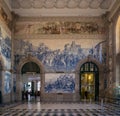 Porto, Portugal - Sao Bento train station interior with beautiful azulejos blue tiles on the wall depicting historic scenes Royalty Free Stock Photo