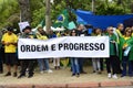 Protesters hold the banner: `Ordem e Progresso` in front of the DCTA